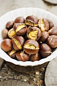 Roasted chestnuts in white bowl