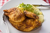 Half a roast chicken with potato and cucumber salad