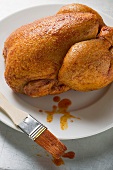 Fresh marinated chicken with basting brush