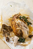 Half a roast chicken with parsley, partly eaten