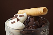 Sundae of chocolate ice cream, cream & wafer curl (close-up)