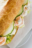 Bread roll filled with shrimps, cucumber and remoulade