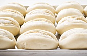 Unbaked baguette rolls on baking tray