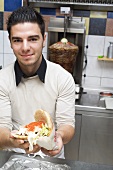 Young chef holding a döner kebab