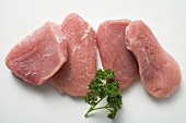 Several slices of pork fillet with parsley