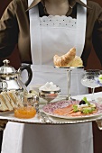 Chambermaid serving luxury breakfast tray