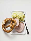 Leberkäse with potato salad & pretzel on paper plate