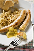 Sausages with sauerkraut,  mustard & bread roll (bites taken)