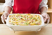 Woman serving macaroni bake