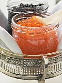Black caviar and Keta caviar in jars