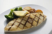 Grilled cod steak with potatoes and broccoli