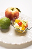 Fruit salad, apple and lime on plate