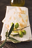 Olive sprig with green olives, crackers