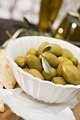 Green olives in white bowl
