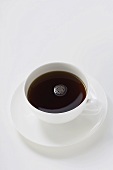 Black coffee in white cup and saucer