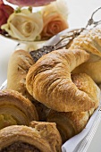 Bread rolls and sweet pastries in bread basket
