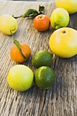 Assorted citrus fruit on wooden background
