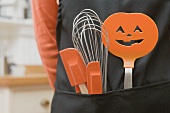 Kitchen tools for Halloween in an apron pocket