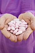 Hands holding sugared almonds