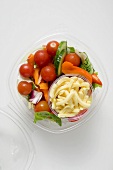 Salad with grated cheese to take away (overhead view)