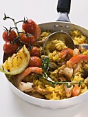 Paella with seafood in frying pan
