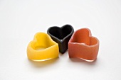 Three pieces of heart-shaped pasta