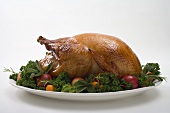 Roast turkey garnished with fruit and herbs