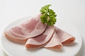 A few slices of Schinkenwurst (ham sausage) with parsley on plate
