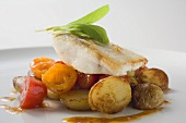 Fish fillet with fried potatoes and cherry tomatoes