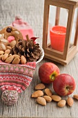 Rustic Christmas decoration with red apples, nuts, lantern