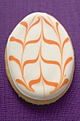 Egg-shaped Easter biscuit on purple linen