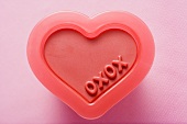 Heart-shaped plastic mould with the words XOXO (Valentine's day)