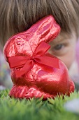 Child looking at red Easter Bunny