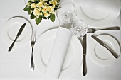 Place-setting in white with fabric napkin and wine glasses