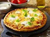 Tomato and mozzarella pizza with basil