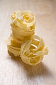 Tagliatelle on wooden background