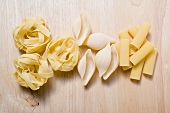 Assorted pasta on wooden background