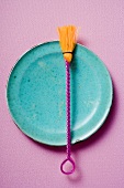 Coloured pastry brush on blue plate