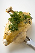 Chicken breast with deep-fried parsley on meat fork
