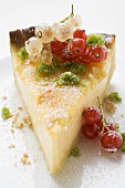 Piece of cheesecake with redcurrants