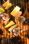 Fruit kebabs on barbecue grill rack