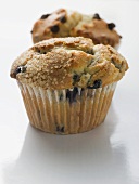 Two blueberry muffins in paper cases