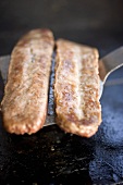 Fried pork sausagemeat on spatula