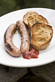 Fried sausages with toasted bread and ketchup