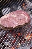 Raw beef steak on a barbecue