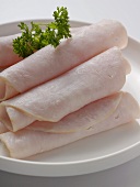 Several ham rolls garnished with parsley