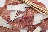Beef carpaccio with Parmesan and grissini (close-up)