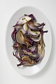 Grilled red onions on white platter