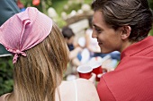 Young couple at a garden party for the 4th of July (USA)