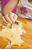 Child cutting out biscuits